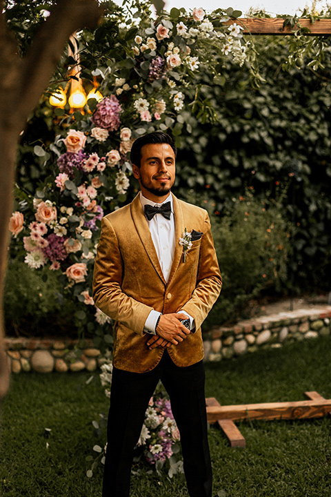  whimsical fairytale wedding with the groom in a gold velvet tuxedo – groom at the altar