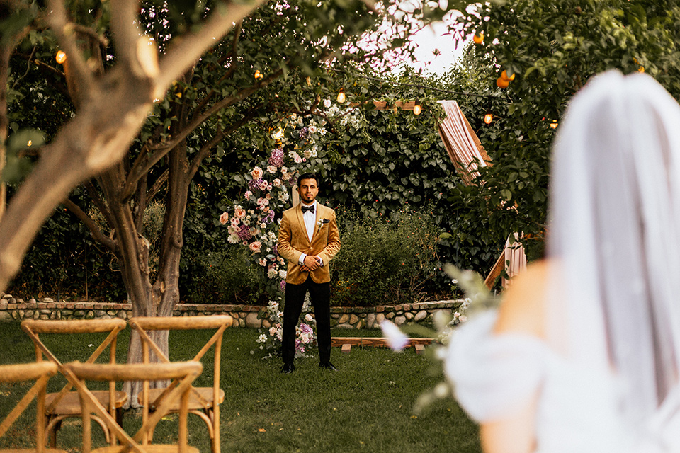  whimsical fairytale wedding with the groom in a gold velvet tuxedo – walking down the aisle