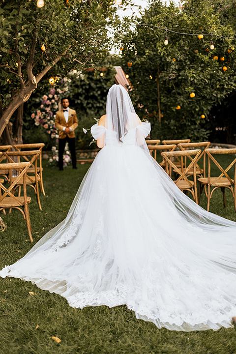  whimsical fairytale wedding with the groom in a gold velvet tuxedo – bride walking down the aisle 