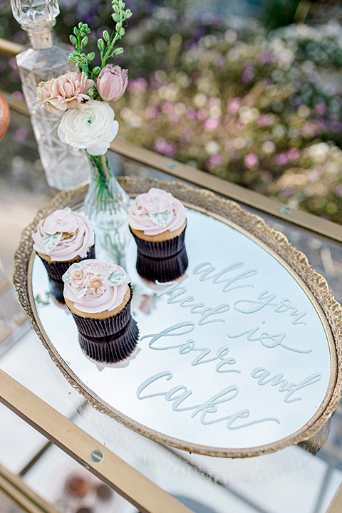  whimsical romance wedding with the bride in a ballgown and the groom in a light grey suit – cupcakes 