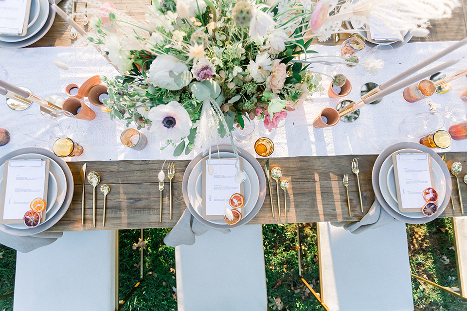  wine country wedding with the bride in a jumpsuit and the groom in a burgundy tux- table faltware 