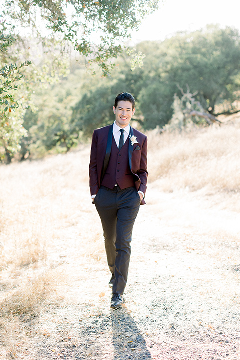  wine country wedding with the bride in a jumpsuit and the groom in a burgundy tux- groom
