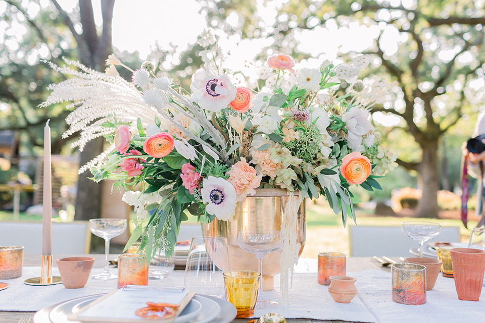  wine country wedding with the bride in a jumpsuit and the groom in a burgundy tux- table decor 