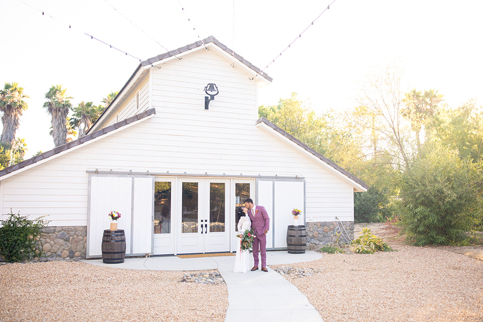  rose pink garden wedding with romantic rustic details – couple outside the venue 