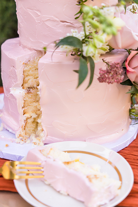  a California wedding with Spanish flare with the bride in a strapless gown and the groom in a gold velvet tux - cake