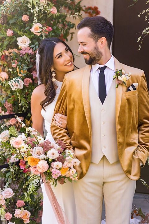  a California wedding with Spanish flare with the bride in a strapless gown and the groom in a gold velvet tux - couple at ceremony 