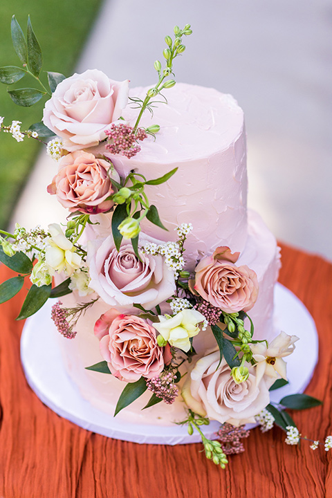  fun pink and champagne wedding with the bride in a pink tulle gown and the groom n a tan and pink look- cake and flatware 