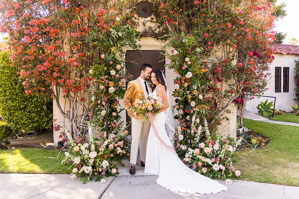  fun pink and champagne wedding with the bride in a pink tulle gown and the groom n a tan and pink look- at the ceremony