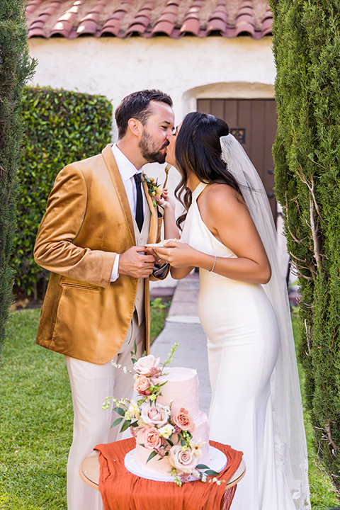  a California wedding with Spanish flare with the bride in a strapless gown and the groom in a gold velvet tux – couple getting ready 