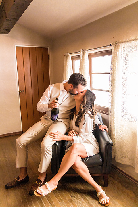  fun pink and champagne wedding with the bride in a pink tulle gown and the groom n a tan and pink look- couple getting ready 