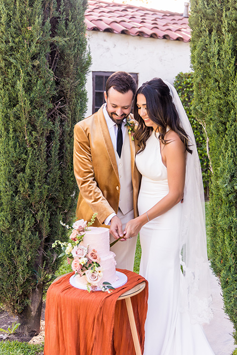  fun pink and champagne wedding with the bride in a pink tulle gown and the groom n a tan and pink look- couple getting ready 