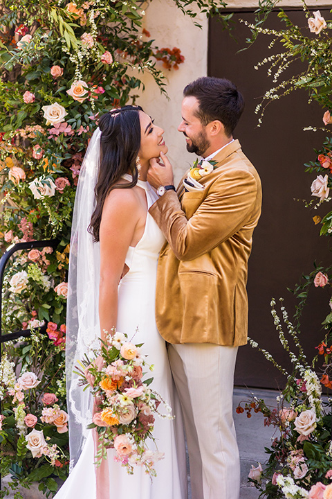  a California wedding with Spanish flare with the bride in a strapless gown and the groom in a gold velvet tux – groom 