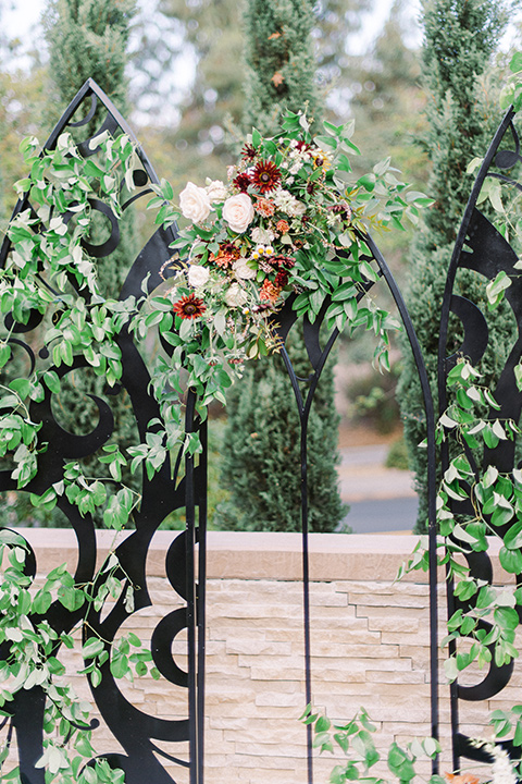 black and white modern wedding at the caramel mountain estate with the bride in a lace gown and the groom in a black velvet tuxedo – close up on the ceremony arch 