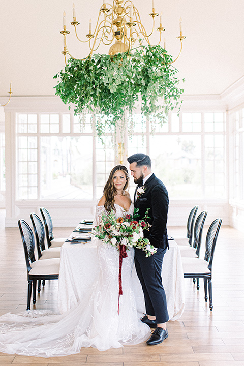  black and white modern wedding at the caramel mountain estate with the bride in a lace gown and the groom in a black velvet tuxedo – couple at the reception 