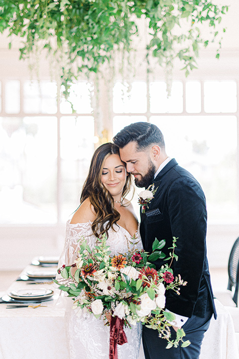  black and white modern wedding at the caramel mountain estate with the bride in a lace gown and the groom in a black velvet tuxedo –  couple at the reception 