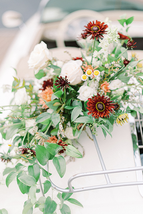  black and white modern wedding at the caramel mountain estate with the bride in a lace gown and the groom in a black velvet tuxedo –  vintage car 