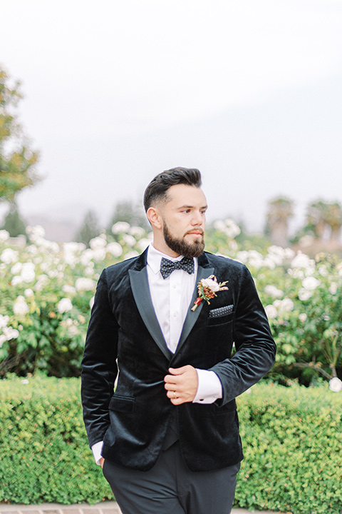 black and white modern wedding at the caramel mountain estate with the bride in a lace gown and the groom in a black velvet tuxedo – groom 