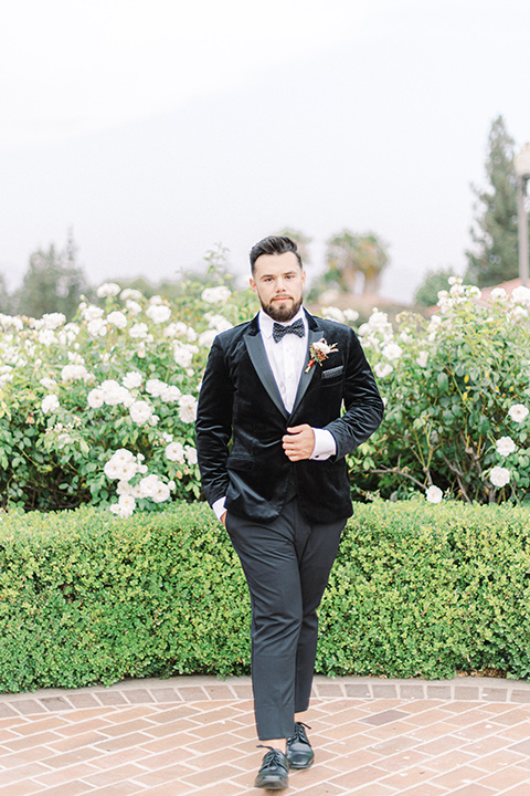  black and white modern wedding at the caramel mountain estate with the bride in a lace gown and the groom in a black velvet tuxedo –  groom 