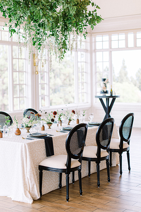  black and white modern wedding at the caramel mountain estate with the bride in a lace gown and the groom in a black velvet tuxedo – black and white wedding reception decor and cake