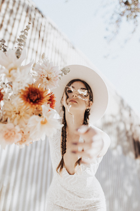  bohemian wedding with neutral colors and the groom in a gold velvet tuxedo – bride in boho gown and wide brimmed hat