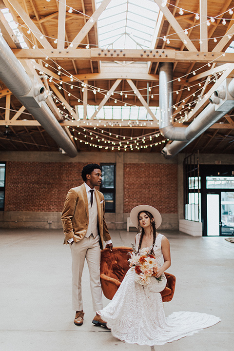  bohemian wedding with neutral colors and the groom in a gold velvet tuxedo – couple at the reception 