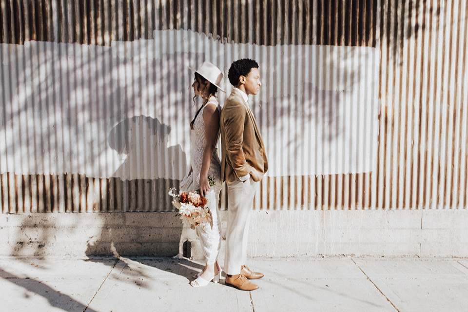  bohemian wedding with neutral colors and the groom in a gold velvet tuxedo – outside the venue 