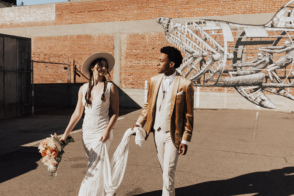  bohemian wedding with neutral colors and the groom in a gold velvet tuxedo – outside the venue 
