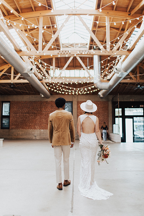  bohemian wedding with neutral colors and the groom in a gold velvet tuxedo – couple at the reception 