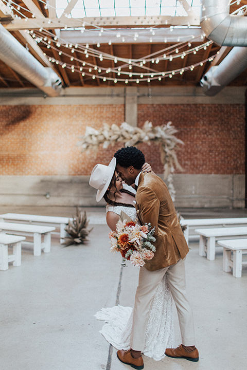  bohemian wedding with neutral colors and the groom in a gold velvet tuxedo – couple at the ceremony 