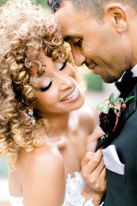  black and white classic wedding with the bride in a modern ballgown with billow sleeves and the groom in a black tuxedo – couple embracing and dancing 