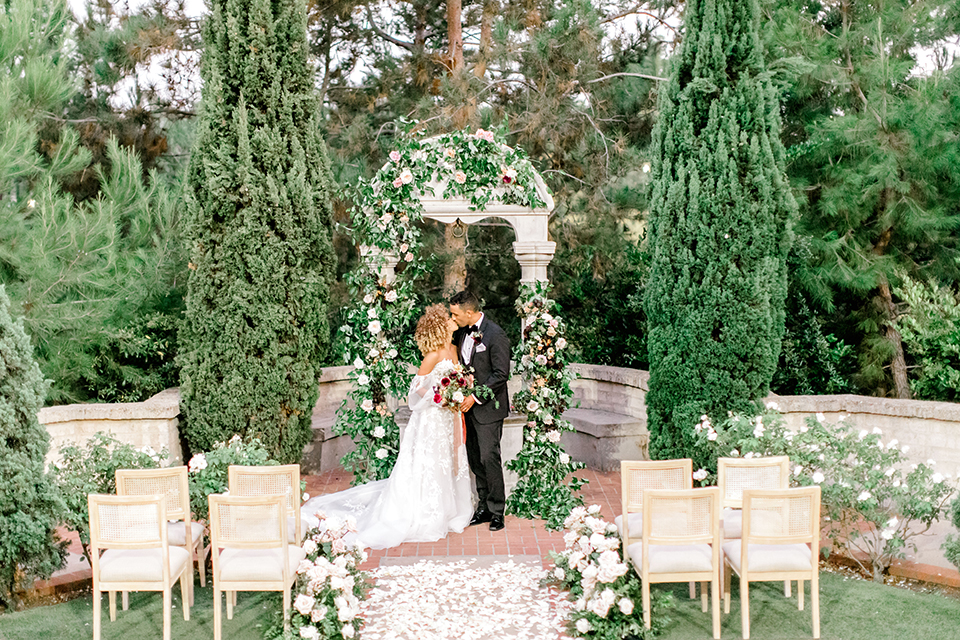  black and white classic wedding with the bride in a modern ballgown with billow sleeves and the groom in a black tuxedo – ceremony space