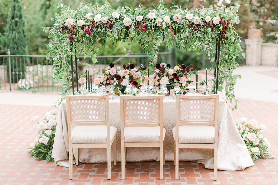  black and white classic wedding with the bride in a modern ballgown with billow sleeves and the groom in a black tuxedo – tables at reception