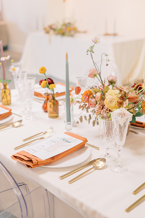  colorful modern wedding with the bride in a fitted gown and the groom in an ivory coat and pink pants – tablescape and linens