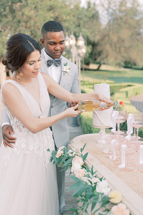  pastel and grey wedding with old world charm - couple pouring drinks 