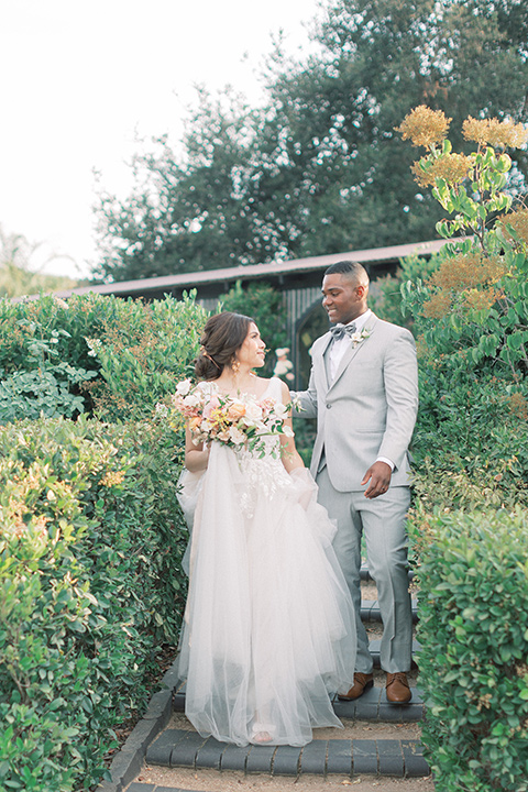  pastel and grey wedding with old world charm - couple walking around the venue 
