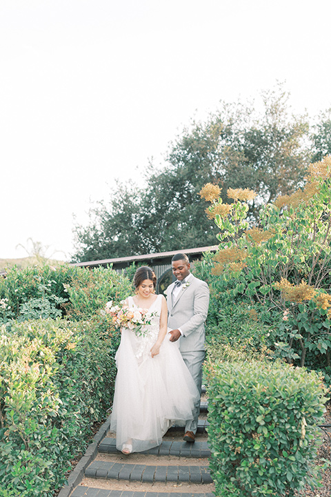  pastel and grey wedding with old world charm - couple walking around the venue 