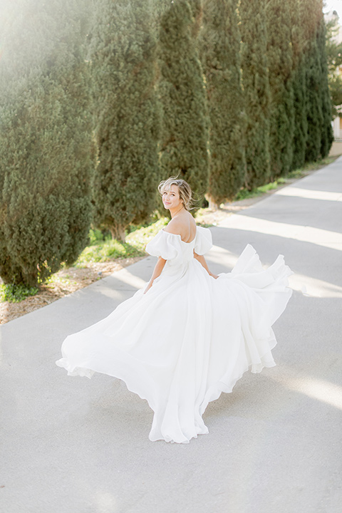  elevated cottagecore wedding design with the bride in a long sleeve ball gown and the groom in a tan suit - bride