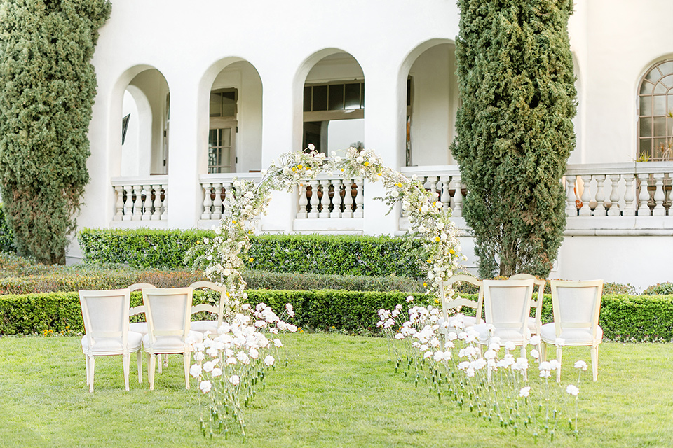  English garden romantic wedding with the bride in an off-the-shoulder gown and the groom in a tan suit – ceremony 