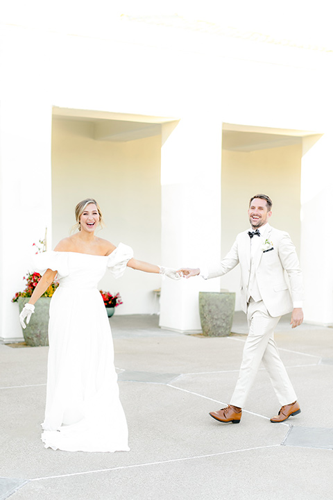  English garden romantic wedding with the bride in an off-the-shoulder gown and the groom in a tan suit – couple dancing 