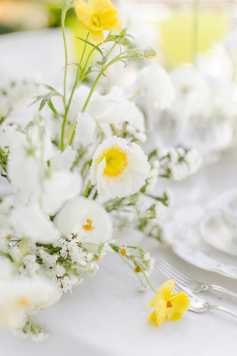  elevated cottagecore wedding design with the bride in a long sleeve ball gown and the groom in a tan suit - table decor 