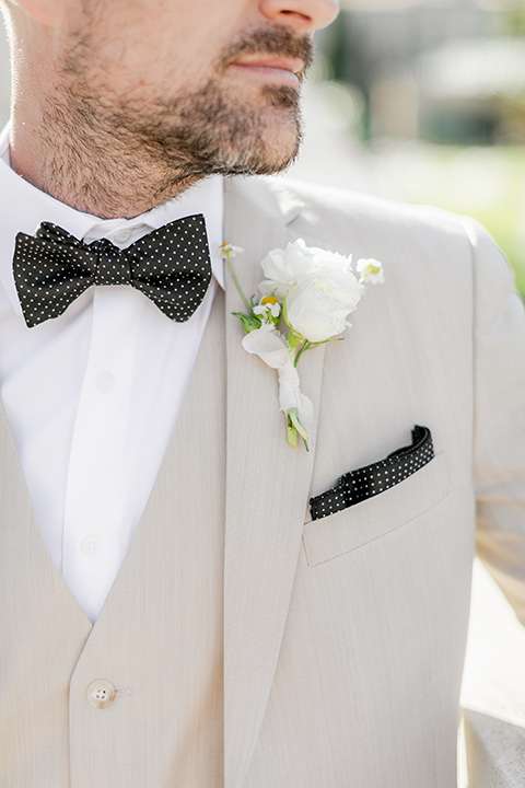  elevated cottagecore wedding design with the bride in a long sleeve ball gown and the groom in a tan suit - groom 