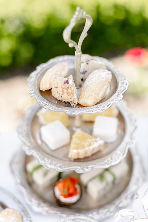  elevated cottagecore wedding design with the bride in a long sleeve ball gown and the groom in a tan suit - desserts 