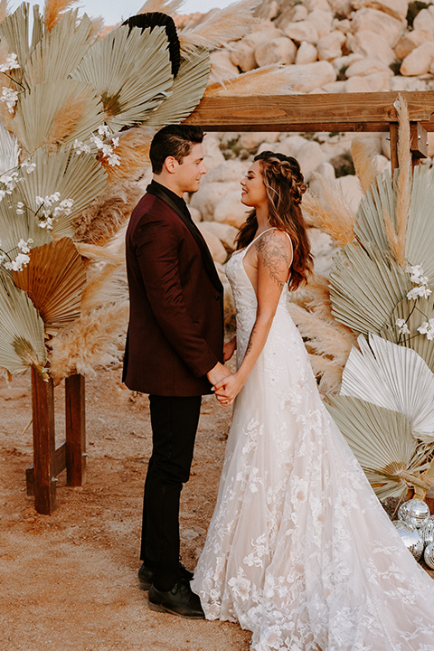  boho burgundy and beige wedding in the dessert – couple at the ceremony 