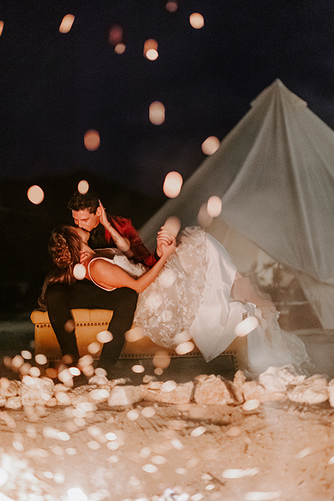  boho burgundy and beige wedding in the dessert – couple by the campfire 