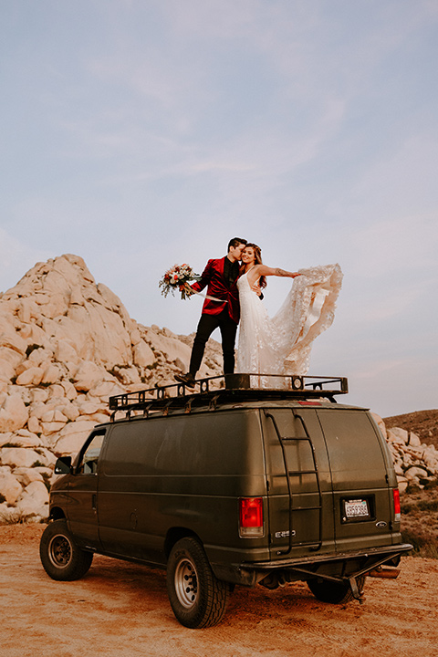  boho burgundy and beige wedding in the dessert – couple on their van 