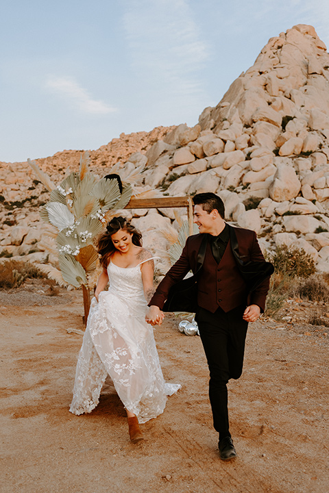  boho burgundy and beige wedding in the dessert – couple at the ceremony 