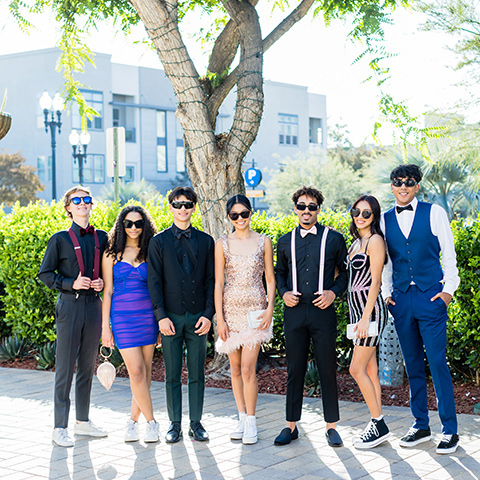  couple in black and pink styles walking to homecoming 