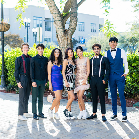  couple in black and pink styles walking to homecoming 