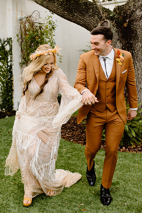  retro boho wedding with amber and brown color scheme – couple laughing and running