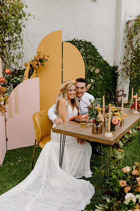  retro boho wedding with amber and brown color scheme – couple sitting at the table